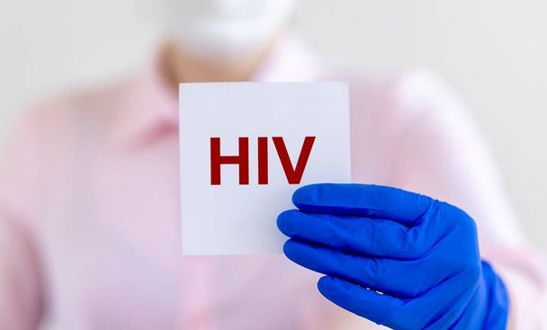HIV acronym - Human Immunodeficiency Virus - word on paper in doctor hands as medical concept. - Fotografie, Obrázek