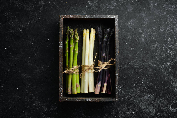 Raw healthy asparagus in a wooden box. Top view. Free space for your text. - Fotografie, Obrázek