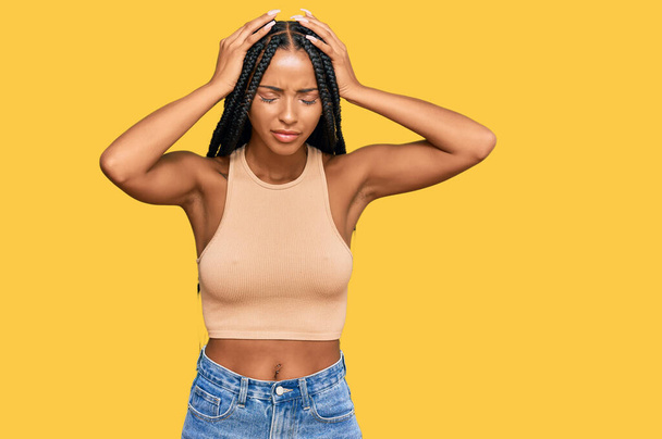 Beautiful hispanic woman wearing casual clothes suffering from headache desperate and stressed because pain and migraine. hands on head.  - Foto, Bild