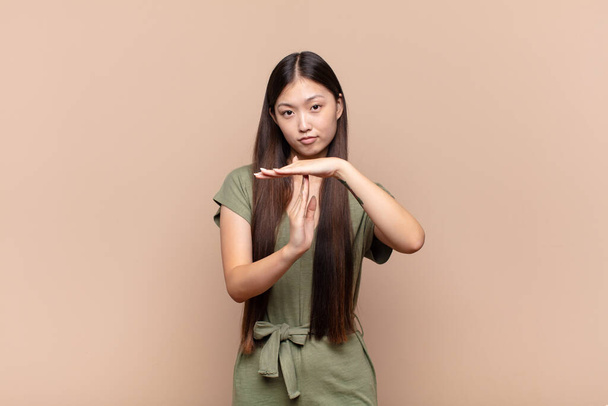 asian young woman looking serious, stern, angry and displeased, making time out sign - Photo, image