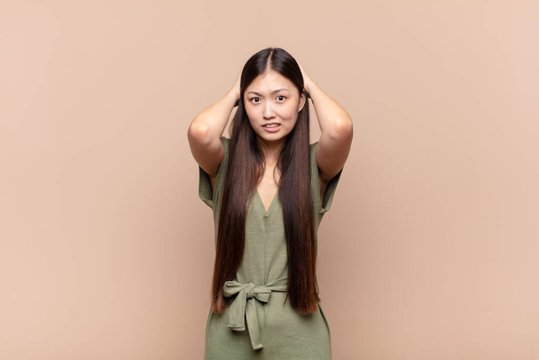 asian young woman feeling stressed, worried, anxious or scared, with hands on head, panicking at mistake - Foto, immagini