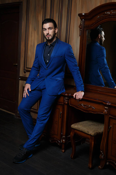 Attractive man in an elegant blue suit in a classic interior. - Zdjęcie, obraz