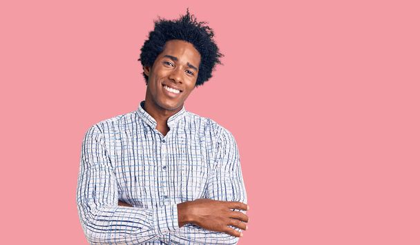 Handsome african american man with afro hair wearing casual clothes happy face smiling with crossed arms looking at the camera. positive person.  - Foto, immagini