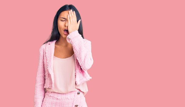 Young beautiful latin girl wearing business clothes yawning tired covering half face, eye and mouth with hand. face hurts in pain.  - Photo, Image