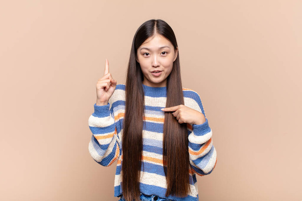 asian young woman feeling proud and surprised, pointing to self confidently, feeling like successful number one - Valokuva, kuva
