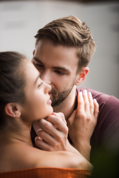 tender man touching face of beloved woman on blurred foreground - Φωτογραφία, εικόνα