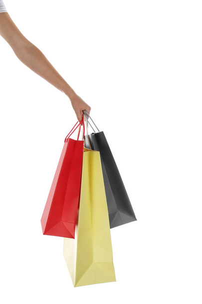 Woman with paper shopping bags on white background, closeup - Foto, Imagem