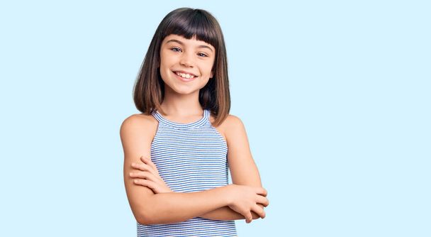 Young little girl with bang wearing casual clothes happy face smiling with crossed arms looking at the camera. positive person.  - 写真・画像