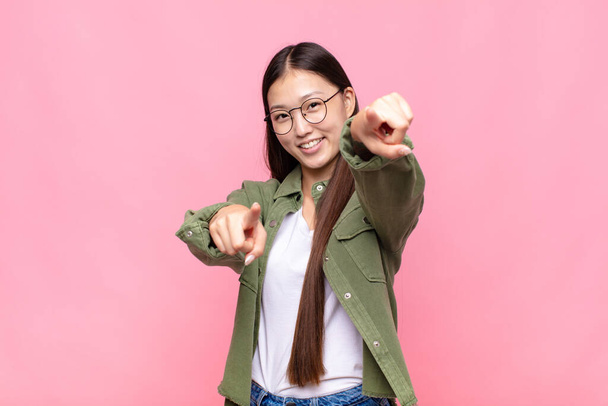 asian young woman feeling happy and confident, pointing to camera with both hands and laughing, choosing you - Photo, Image