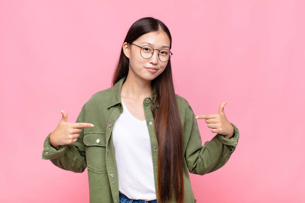 asian young woman looking proud, arrogant, happy, surprised and satisfied, pointing to self, feeling like a winner - Φωτογραφία, εικόνα
