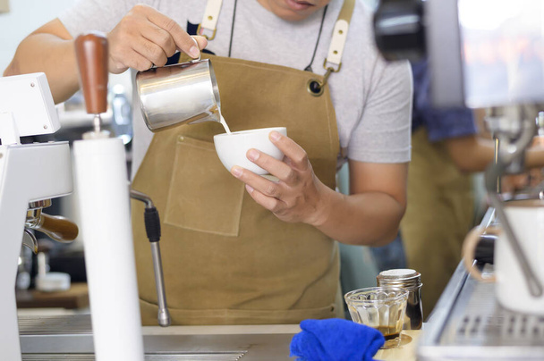 A Barista making hot latte art in coffee shop - Fotoğraf, Görsel