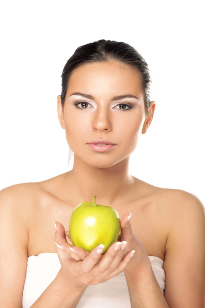 Young woman with a green apple - Φωτογραφία, εικόνα
