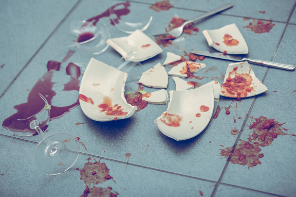Broken Plate or broken water glass on the on the floor in the kitchen The concept of accidents in the kitchen is dangerous for the body and young children inside the house. - Photo, Image