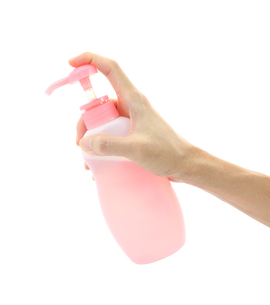 Hand apply bottle pump on white background. - Photo, image