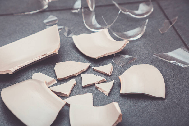 Broken Plate or broken water glass on the on the floor in the kitchen The concept of accidents in the kitchen is dangerous for the body and young children inside the house. - 写真・画像