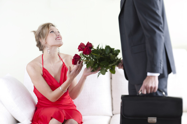 Receiving red rosesHappy and surprised woman receiving red roses - Photo, Image