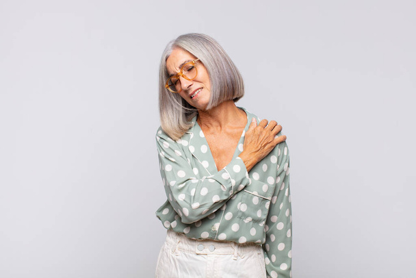 gray haired woman feeling tired, stressed, anxious, frustrated and depressed, suffering with back or neck pain - Фото, изображение