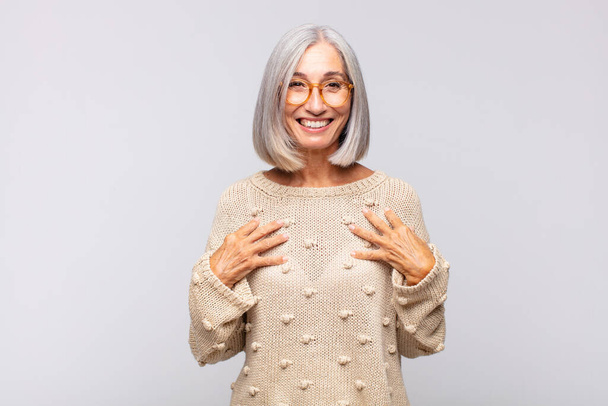 gray haired woman looking happy, surprised, proud and excited, pointing to self - Photo, Image