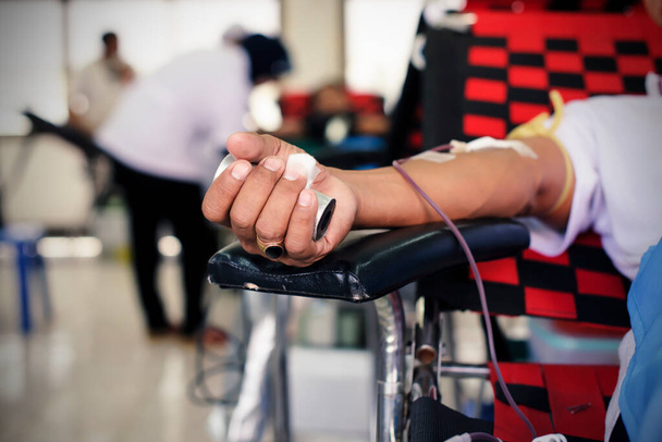 Hands squeezing while donating blood - Valokuva, kuva