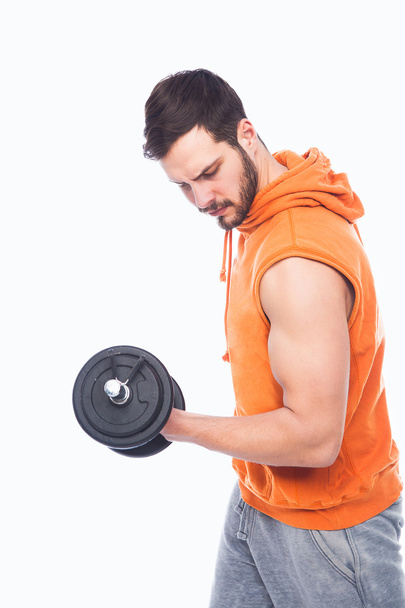 young man lifting dumbbell - Foto, imagen