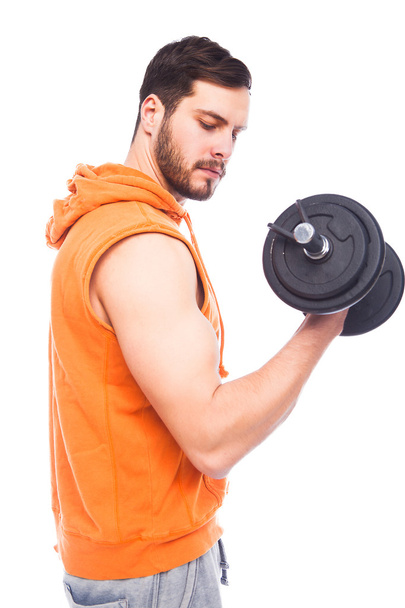 young man lifting dumbbell - Foto, afbeelding