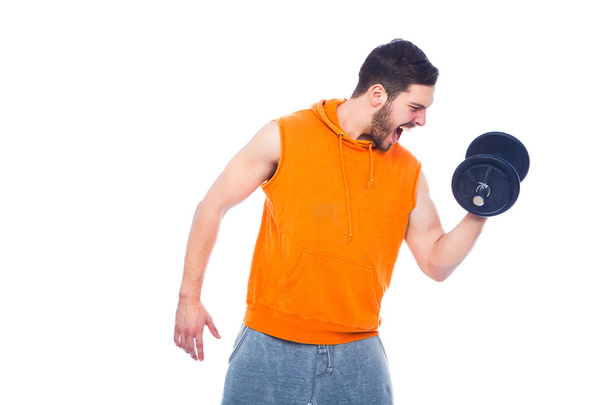 young man lifting dumbbell - Фото, изображение