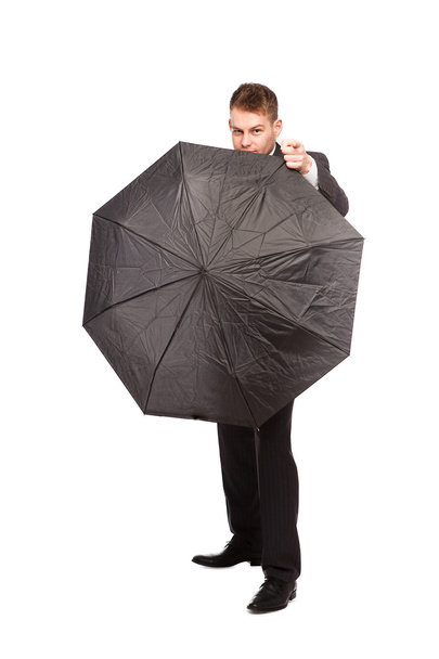 businessman pointing behind an umbrella - Foto, Imagem