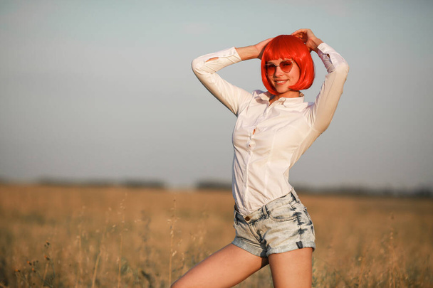 beautiful young woman in pink glassesand red hair - Foto, Imagem