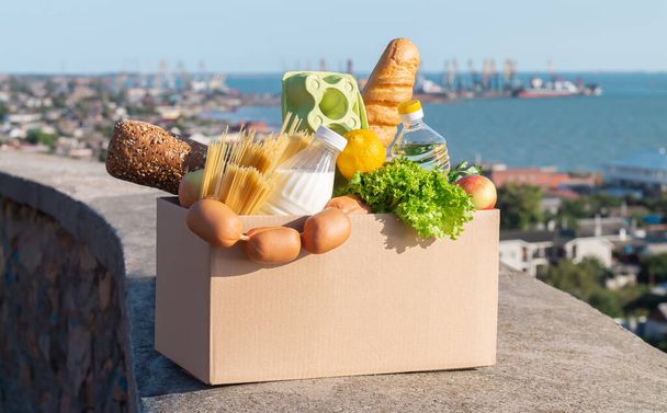 Παράδοση τροφίμων χωρίς επαφή με την έννοια της καραντίνας. Κουτί γεμάτο φρέσκα λαχανικά υπαίθρια - Φωτογραφία, εικόνα