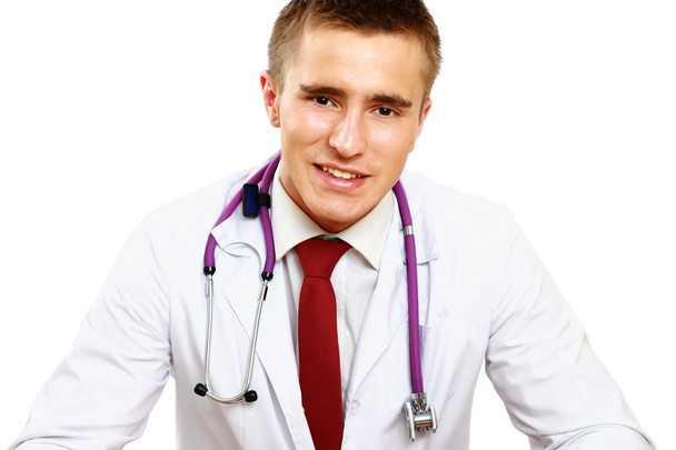 Male doctor working at desk - Photo, image