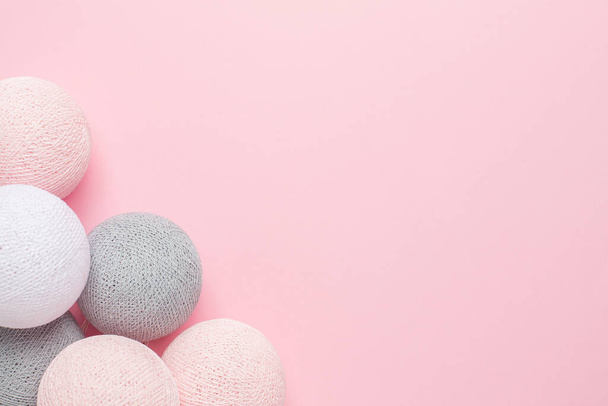 Pink, grey and white balls on a pastel background top view with copy space - Fotó, kép