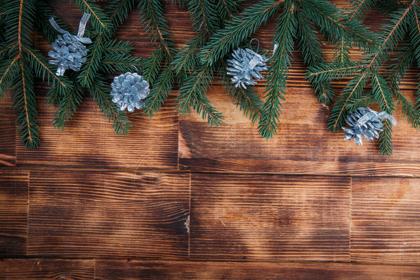 Christmas background, Christmas tree and cones on a wooden background - Valokuva, kuva
