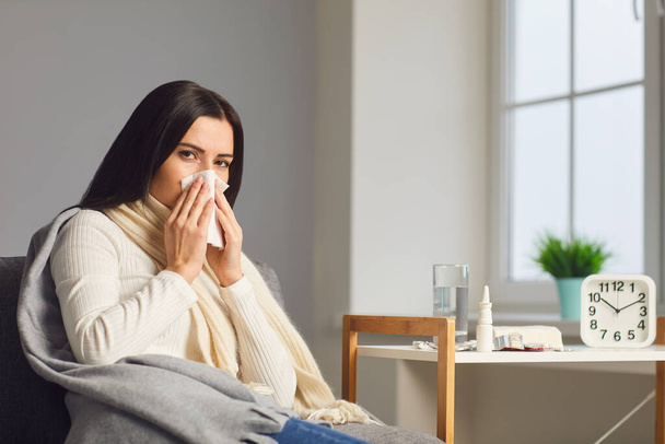 Unhealthy woman suffering from virus or infection at home, copy space. Female patient treating cold symptoms indoors - Foto, afbeelding