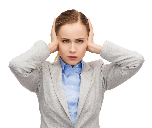Stressed businesswoman with covered ears - Foto, afbeelding