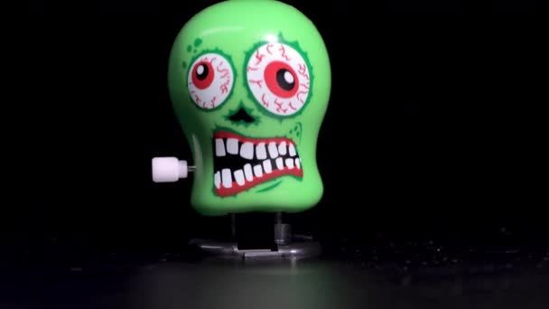 Green wind up skull toys moving on surface - Footage, Video