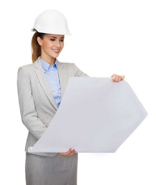 Smiling architect in white helmet with blueprints - Foto, imagen
