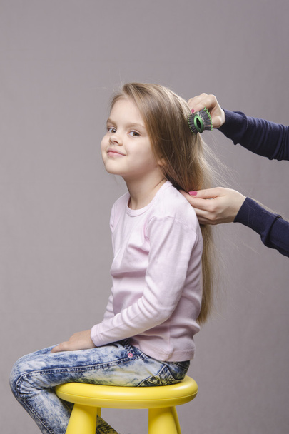 Hairdresser brushing her long hair girls - Fotografie, Obrázek