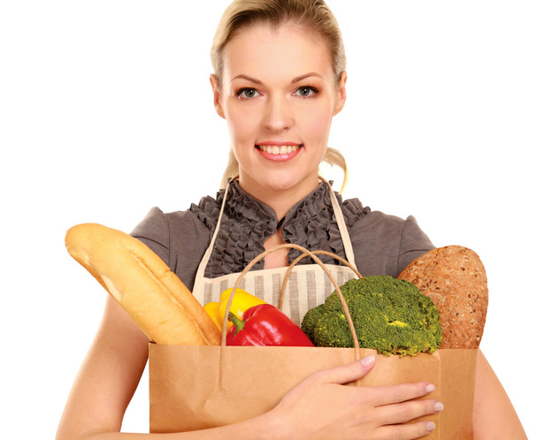 Woman in apron holding grocery bag - Zdjęcie, obraz