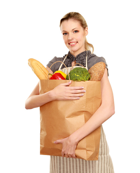 Woman in apron holding grocery bag - Foto, Imagen