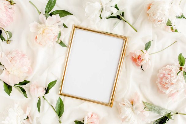 Gold frame decorated of beautiful beige peonies. Flat lay, top view. Valentines background. Floral frame. Peony texture. - Фото, изображение