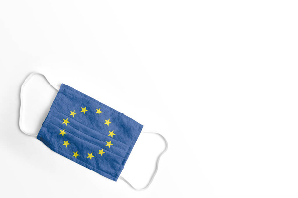 Face mask with European Union flag printed, on white background, isolated. - Photo, Image