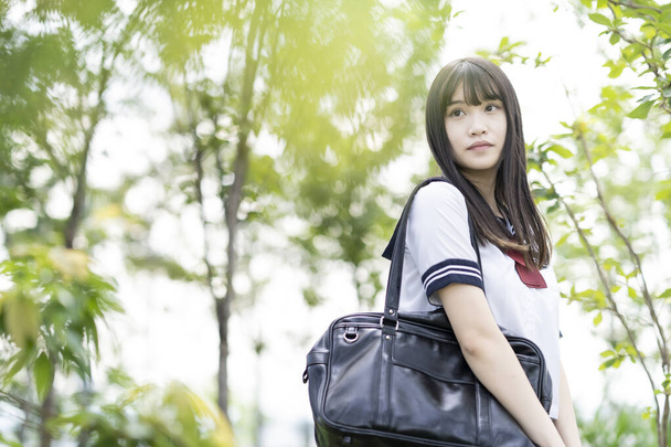female asian high school student with a calm look outdoors - Photo, Image