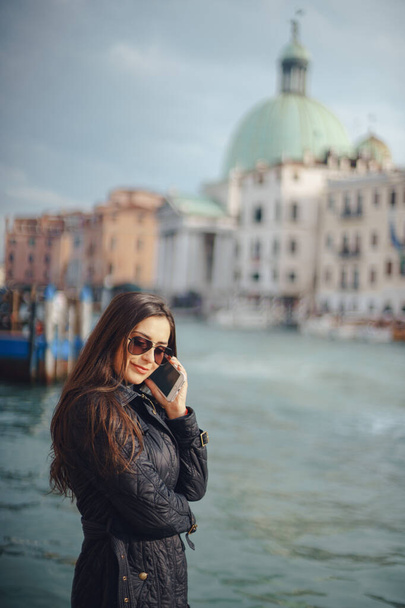girl talking on the phone and taking pictures in Venice - Фото, изображение