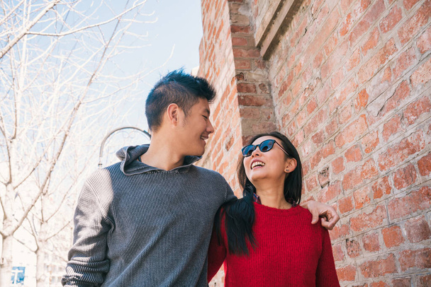 Portrait of young Asian couple in love walking in the city and having good time together. Love concept. - Photo, image