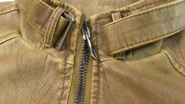 Zipper on the brown leather jacket unfolds. - Footage, Video