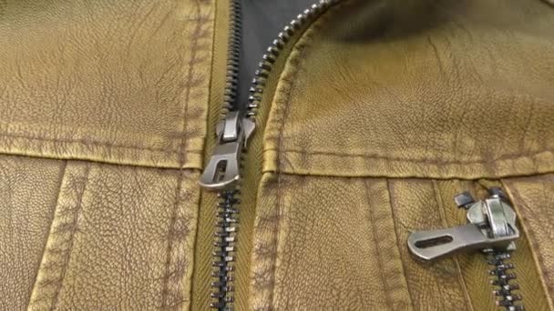 Zipper on the brown leather jacket unfolds. - Footage, Video