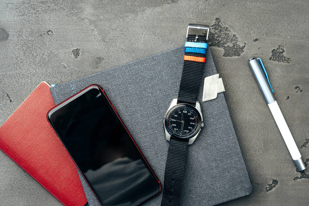 Mens accessories such as smartphone and watch on dark grey table - Foto, Bild