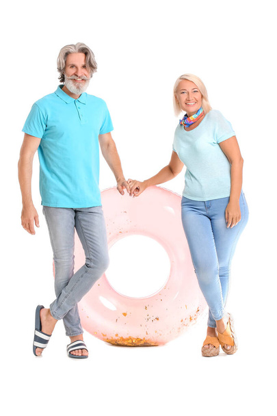 Mature couple with inflatable ring on white background - Fotografie, Obrázek