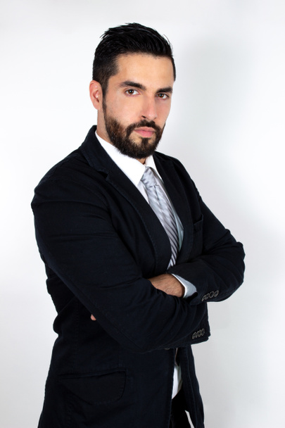 Handsome young bearded man in suit with crossed arms. Attractive stylish businessman. Medium shot. White background. - Fotografie, Obrázek