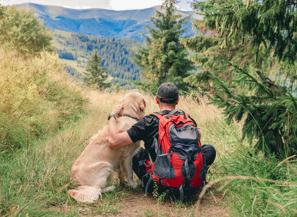 Man on trekking trail next to dog - Photo, Image